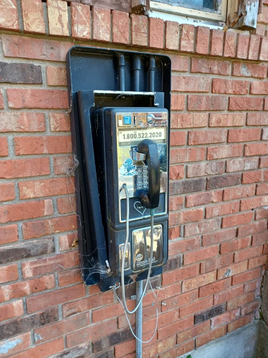 a cell phone sitting on top of a street pole