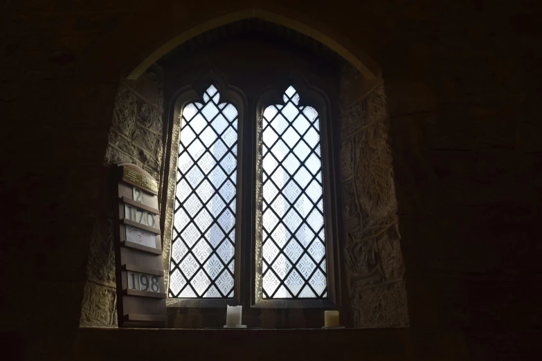 a window in a church with book shelves beside it