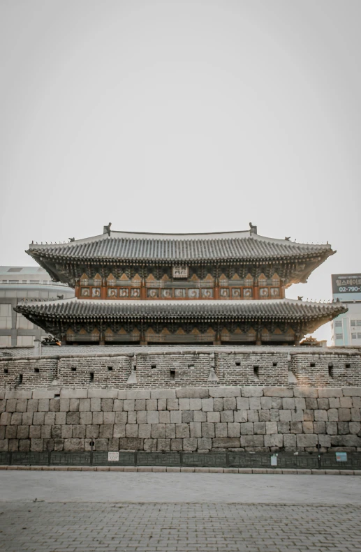 an asian building with an attached clock on the top