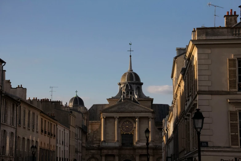 a clock tower near several buildings in the city