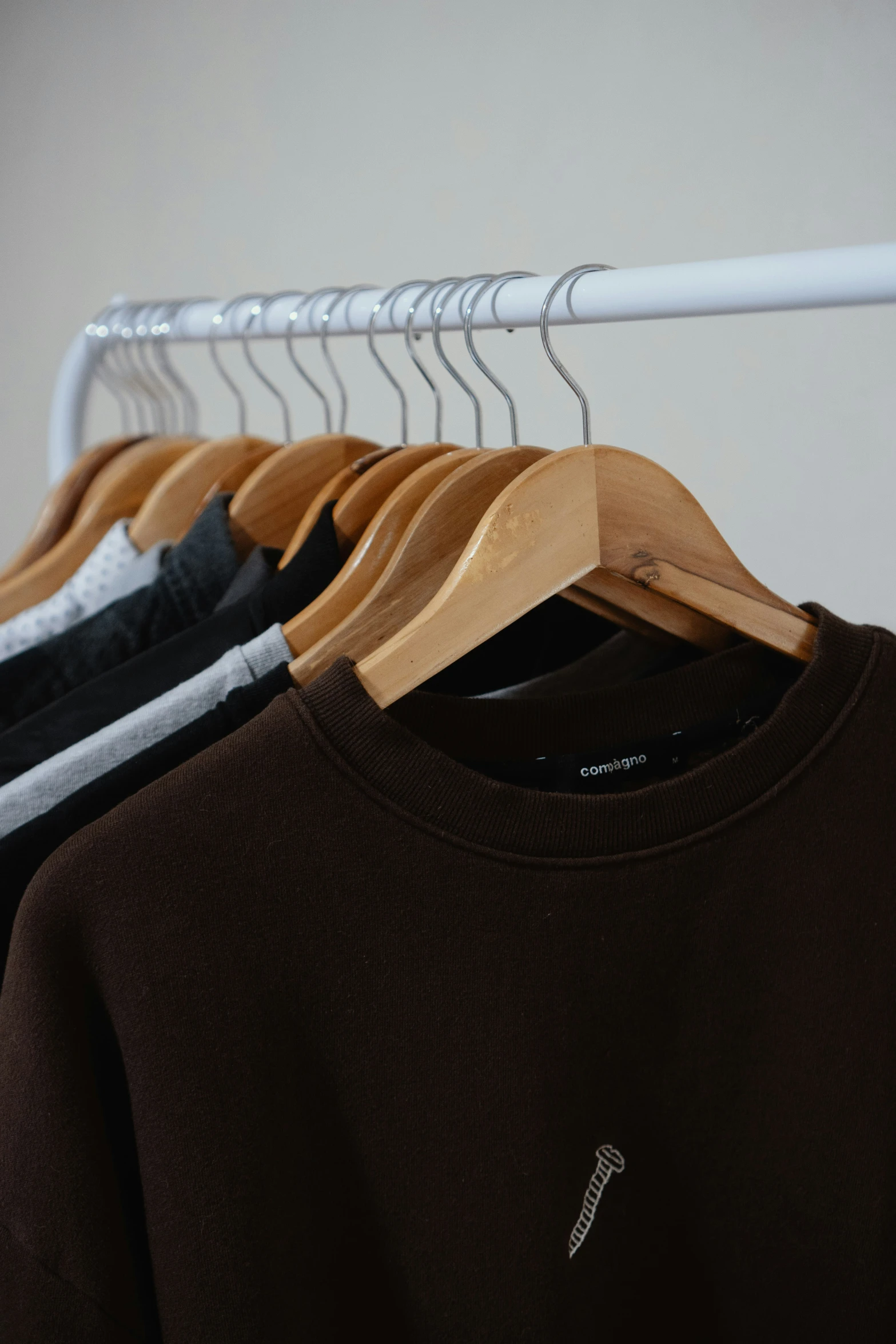 an un - made brown shirt is hanging from a hanger