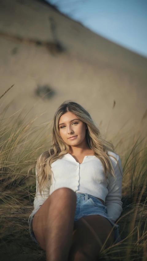 a woman is posing on a dune dunes