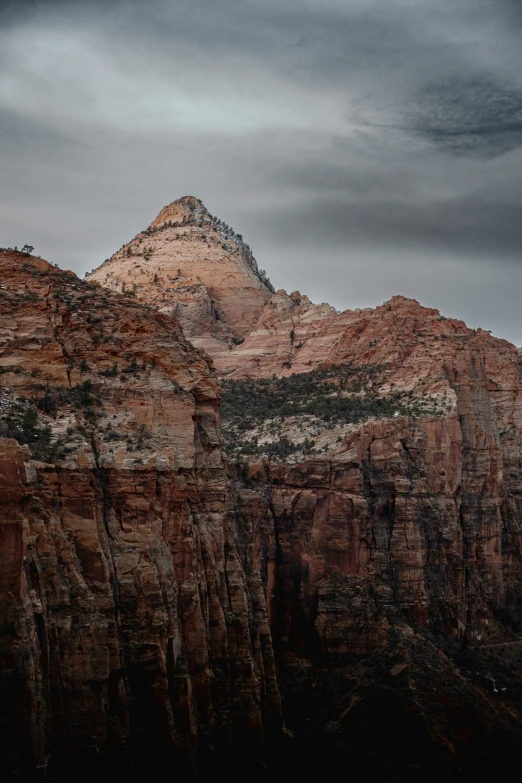 a mountain in the distance with a cloudy sky in the background