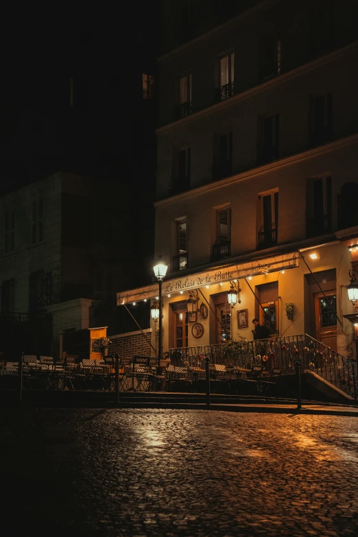 a restaurant lit up at night on the street