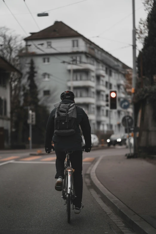 a man on a bicycle is going to cross a busy street