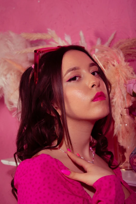 a beautiful woman in a pink top sitting down