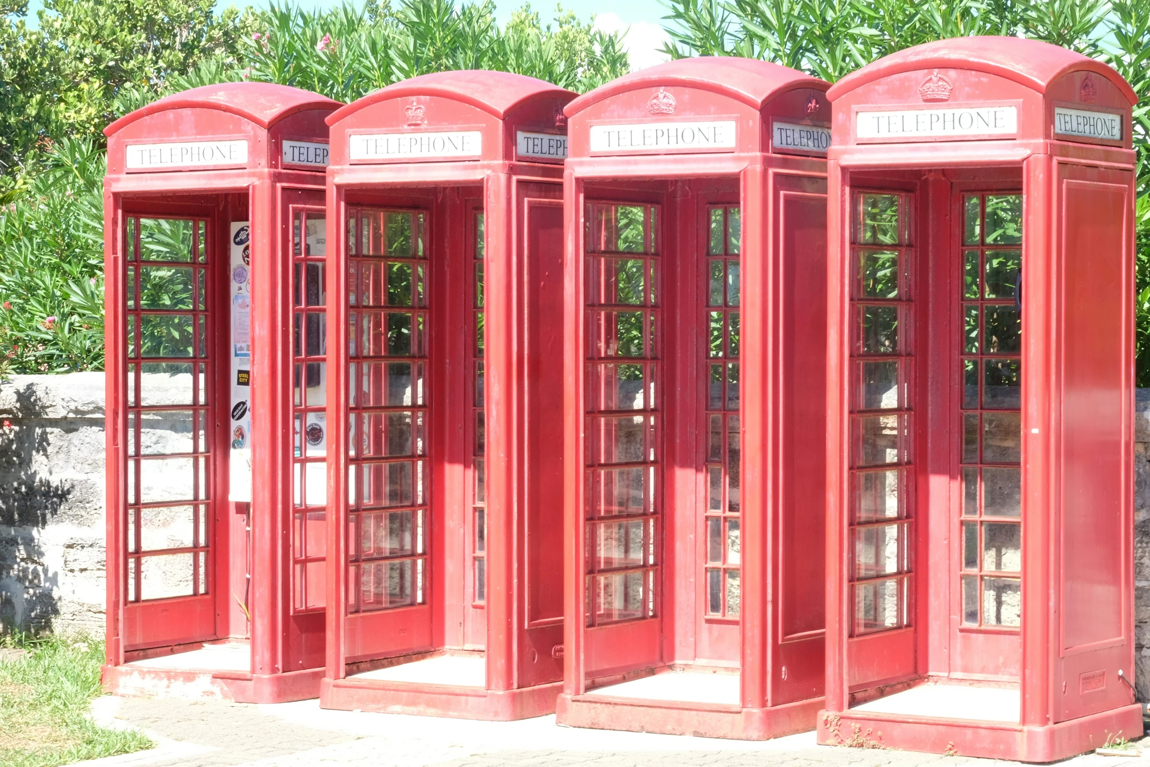 three red cell phones are in a row