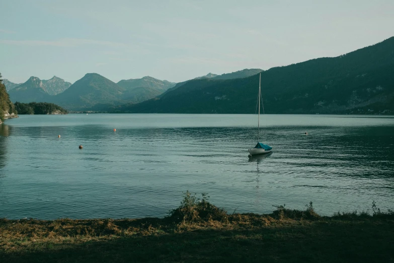 a boat is sitting in the still water