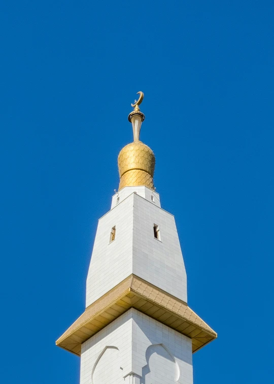 a gold topped roof is seen against a blue sky