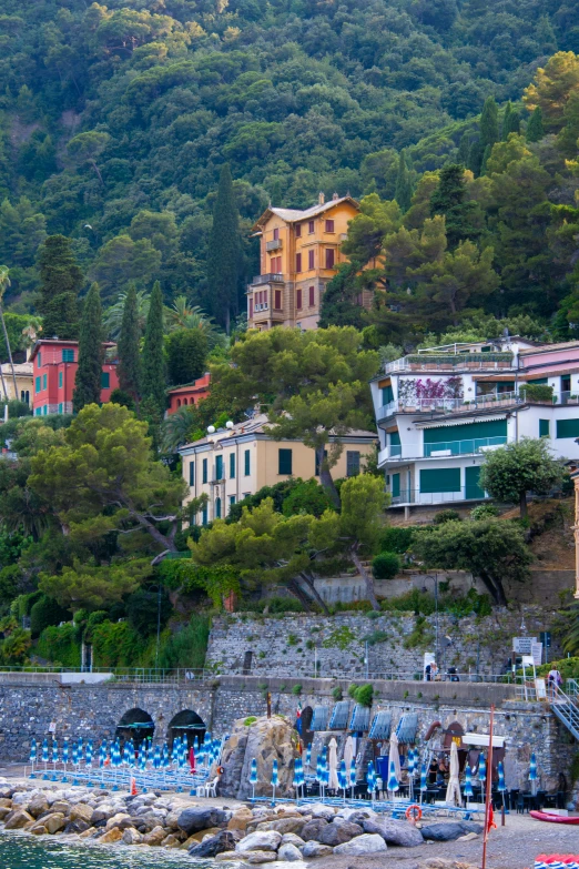 an italian coastal town sits on a hill above the ocean
