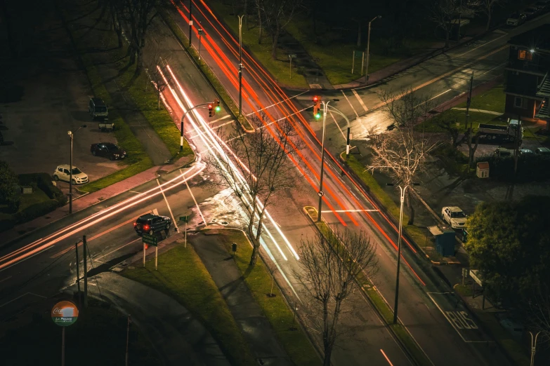 an overhead view shows a city street with bright lights and cars