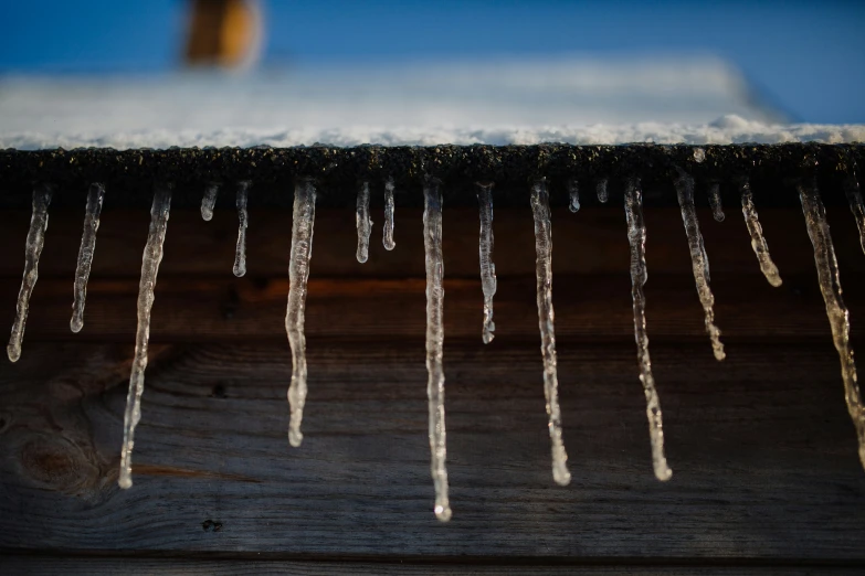 icicles on the roof of a wooden structure