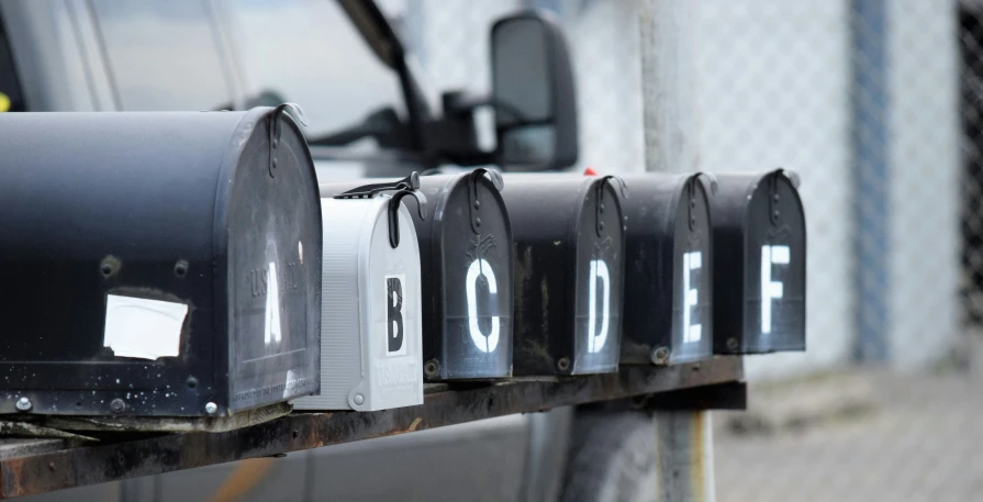 an open mailbox with some white letters