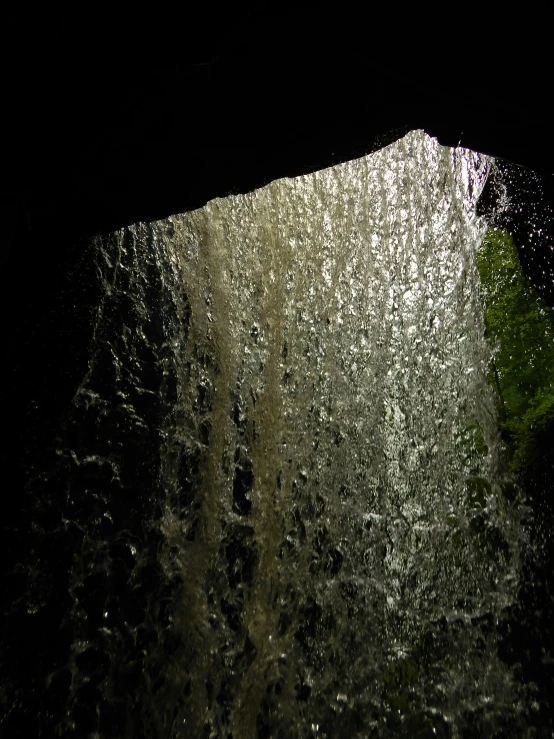 the inside of an underwater cave with water falling out