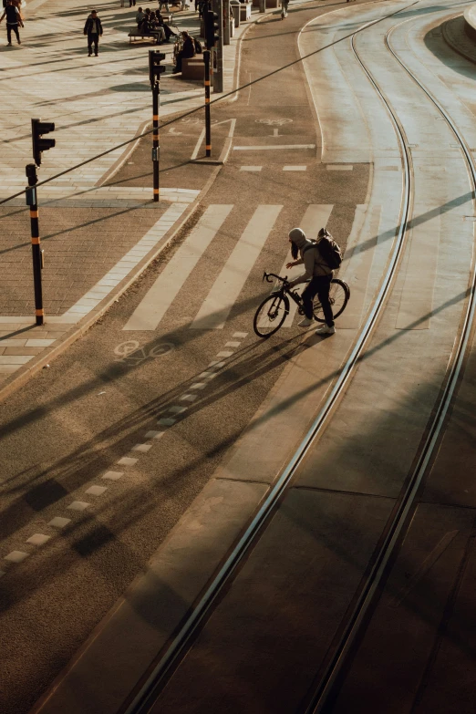 a man riding a bike down the middle of a road