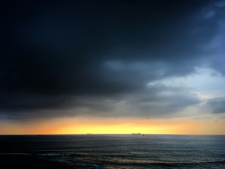 some water a ship and some clouds and a sky