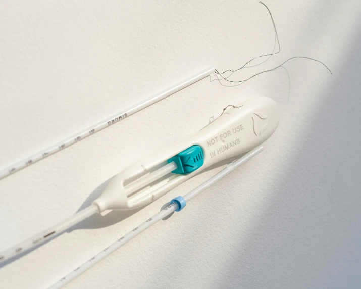 a toothbrush attached to a surface with wires