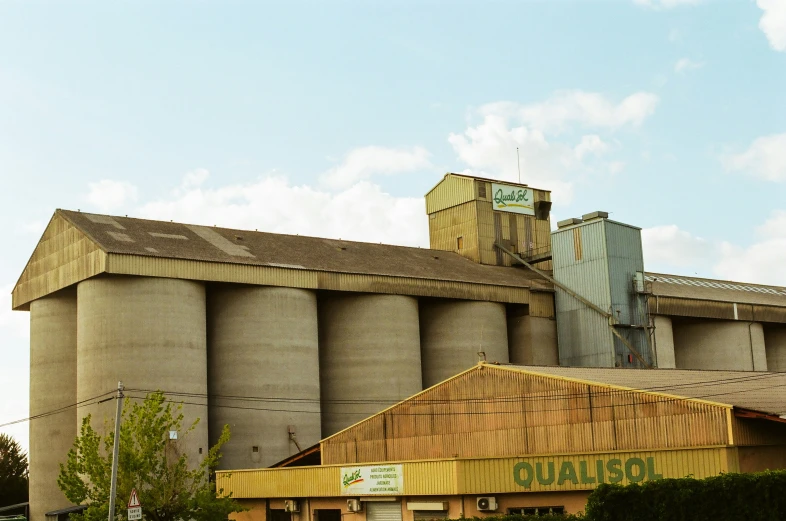 a factory with many silos and an old sign