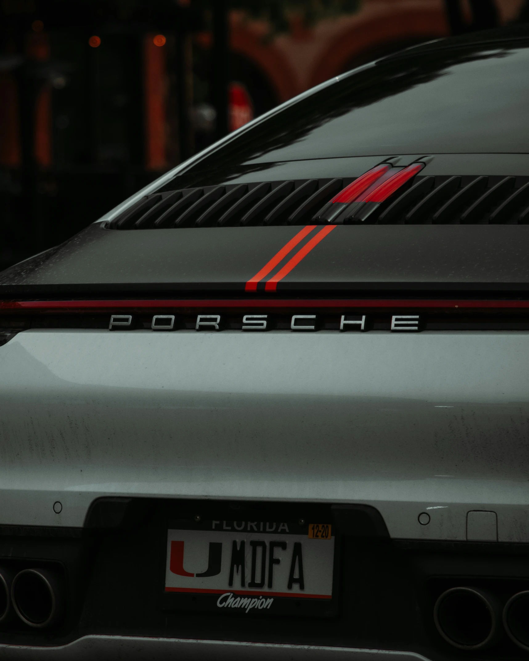 the back end of a silver porsche