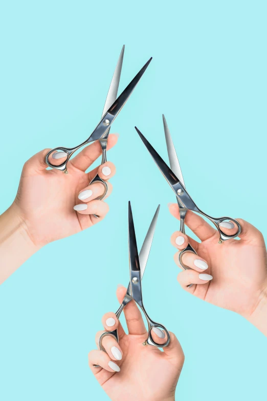 there are four hands holding scissors and pointed them