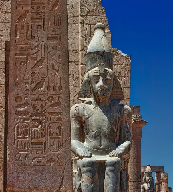 the statues at the top of the building are of ancient egypt