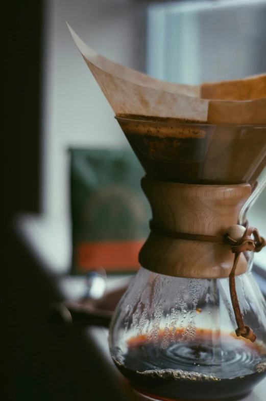 a wooden cone is wrapped in brown paper