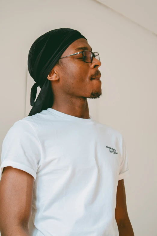 a person standing wearing a white shirt and beanie