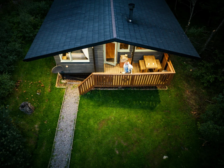 a deck on a house lit up by lights at night