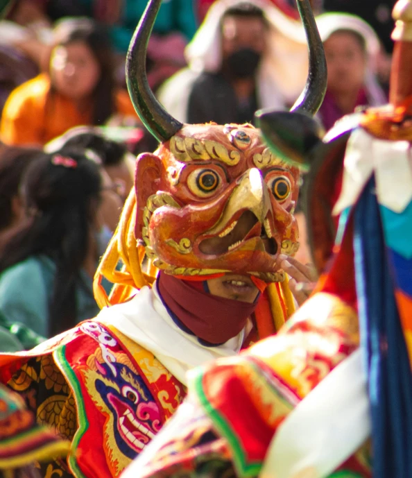 a group of people watching and dancing a dragon dance