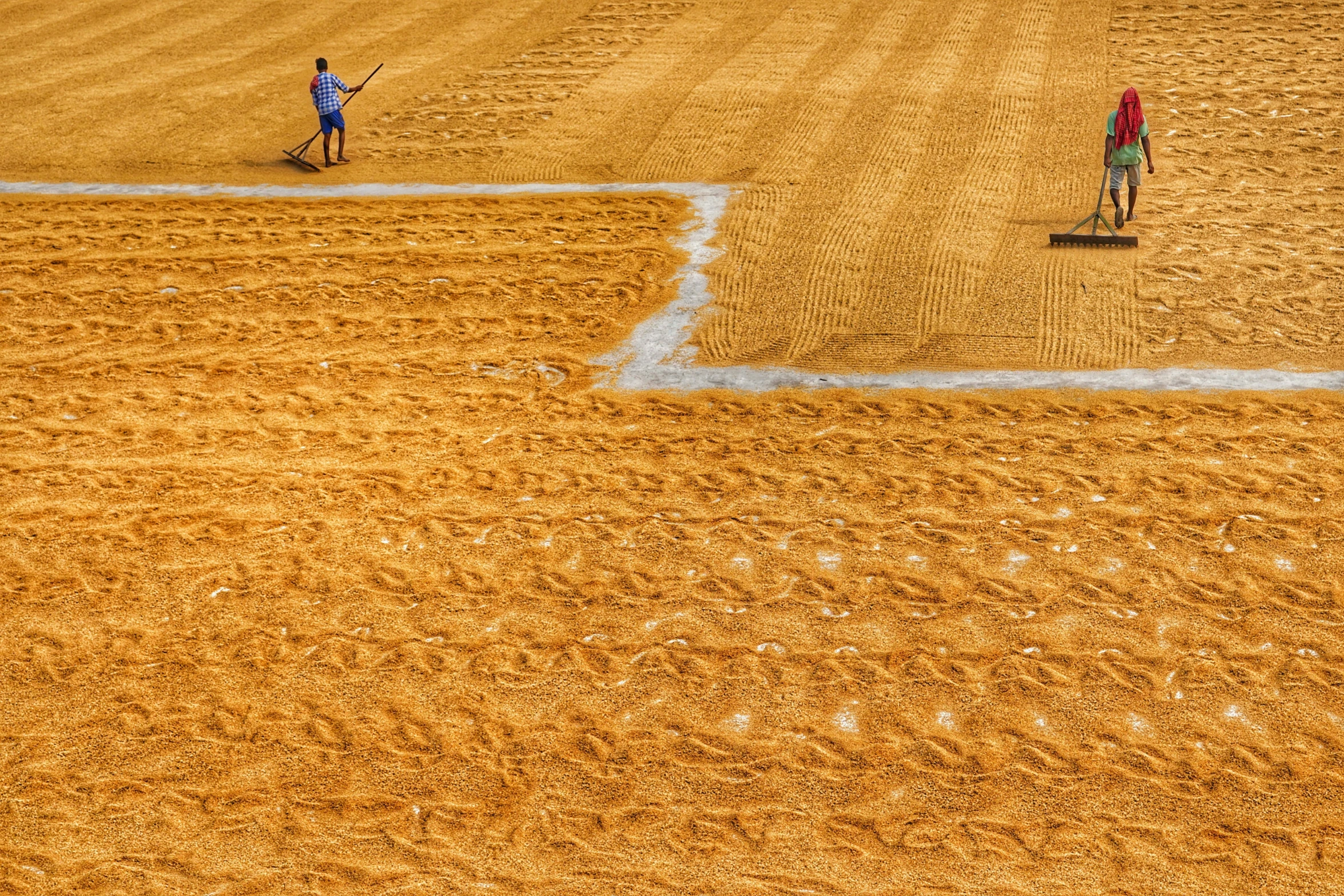 two baseball players are running in to the batters box