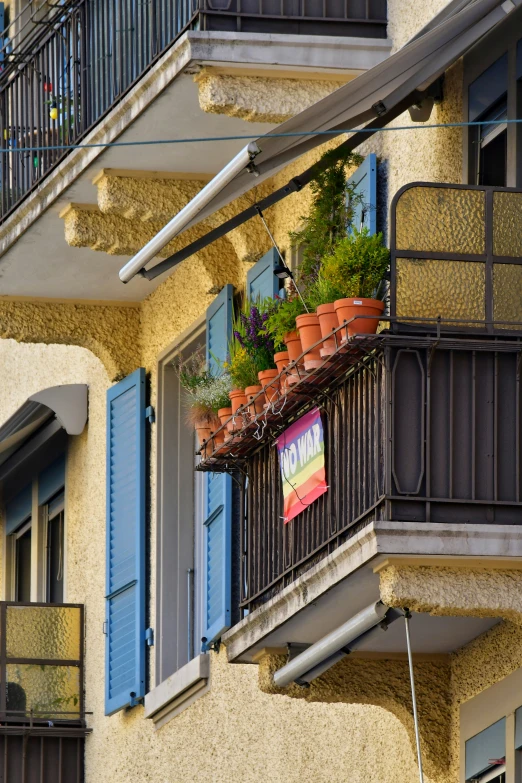 a small balcony with flower pots in it