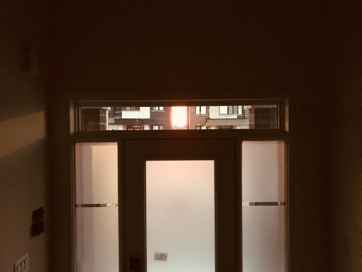 an open door with glass panes at night