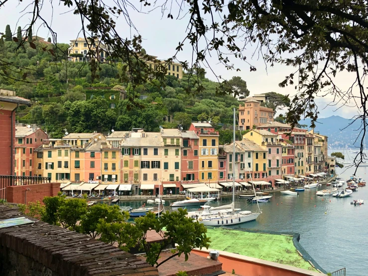 boats sit along the shoreline at a town on a mountain