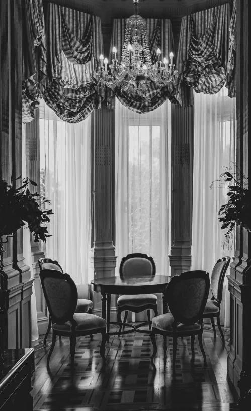 an ornate dining room with chandelier hanging from the ceiling