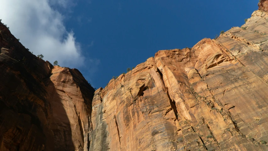 an airplane flying over mountains in a valley