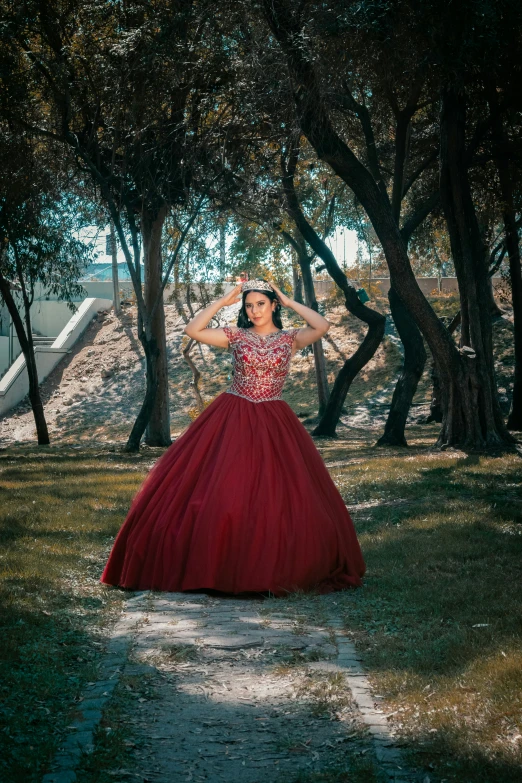 the young woman is wearing a long red dress