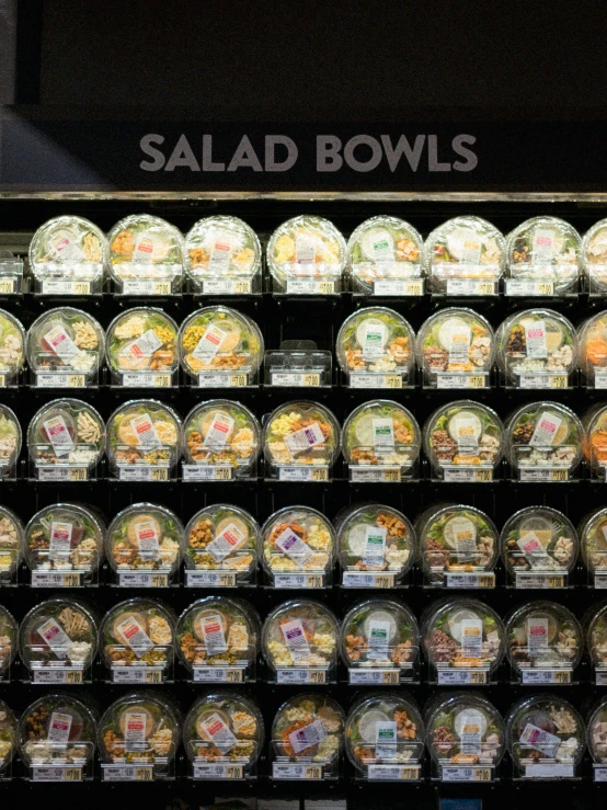 a display case filled with different kinds of salads