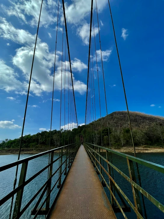 the wooden walkway has a long hanging chain