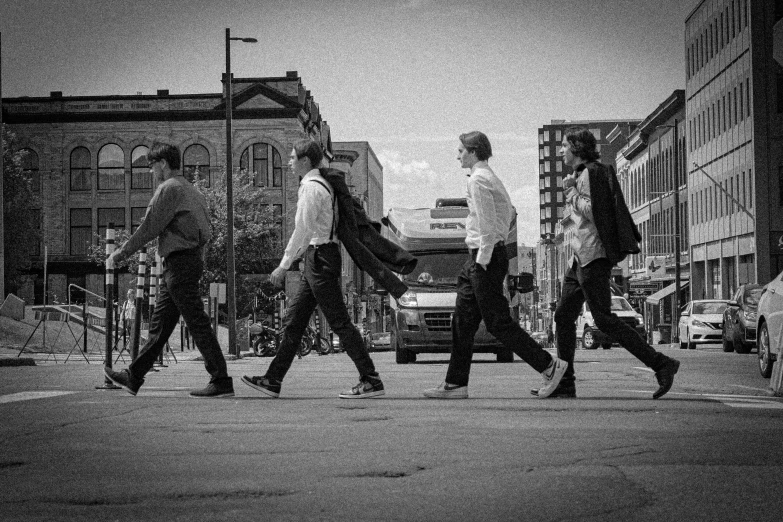 several people walk down a city street