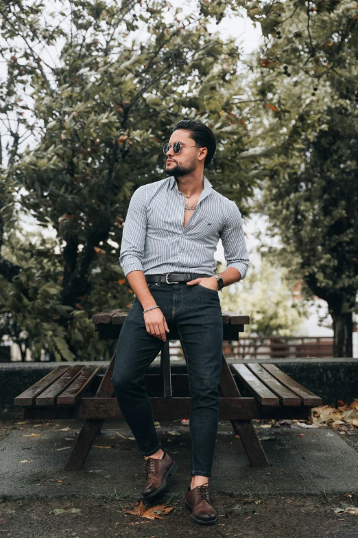 a man standing in front of a park bench