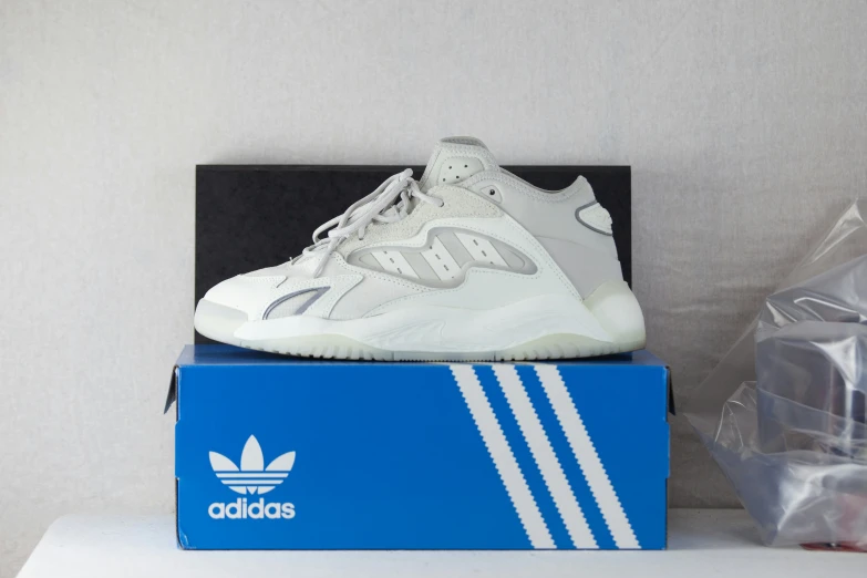 the adidas sneakers are sitting on top of a box