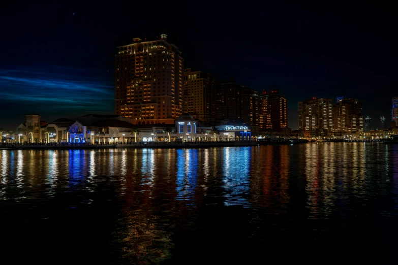 the water is still clear but it reflects lights on the buildings