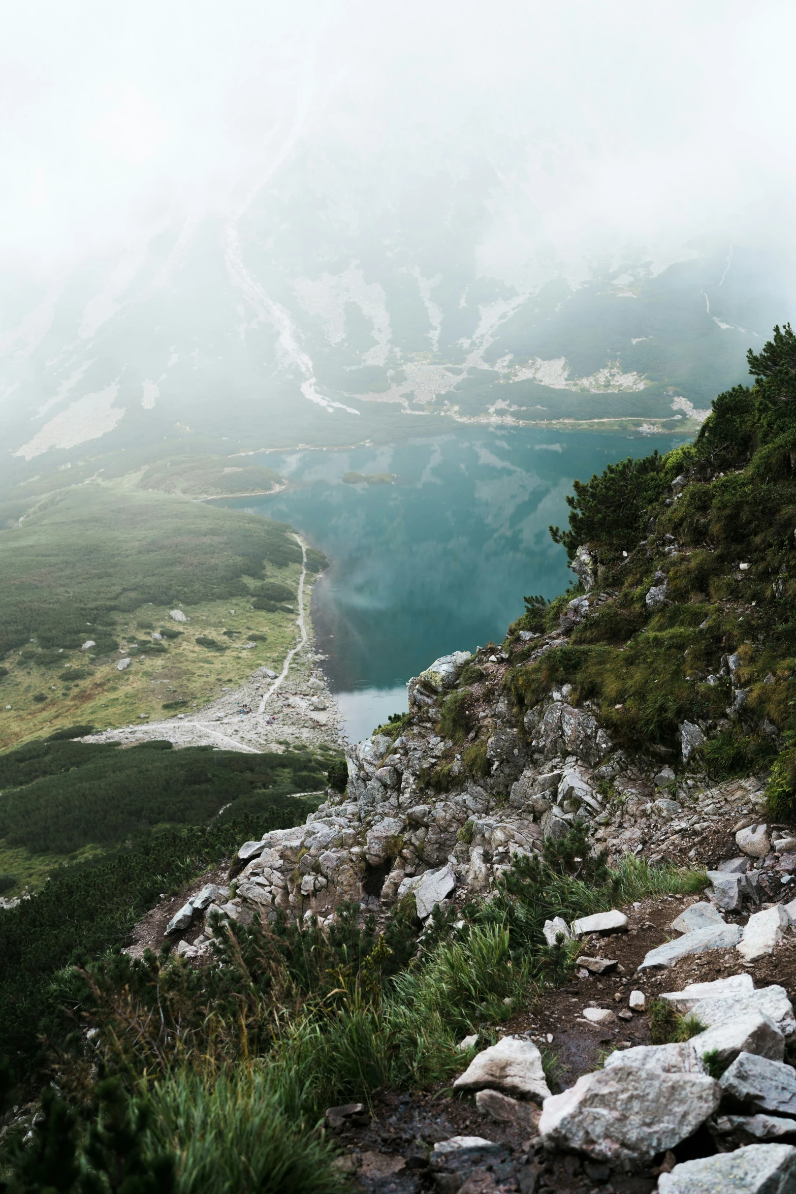 there are many mountains in the distance and blue waters