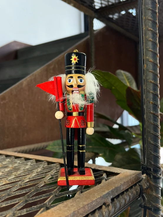 a toy soldier stands on the ledge of a home