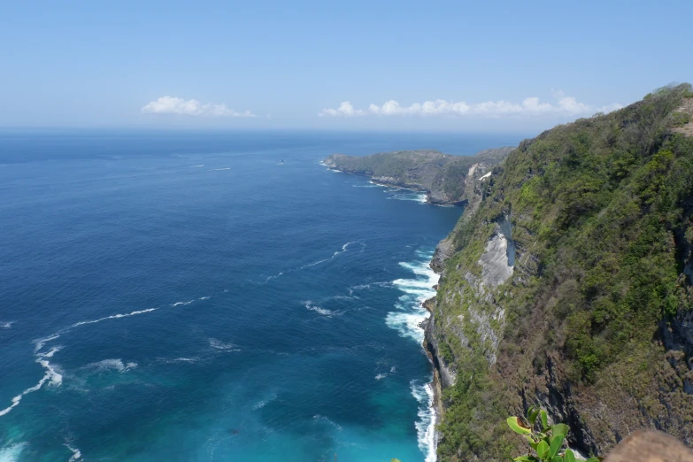 an ocean view from a hill side road