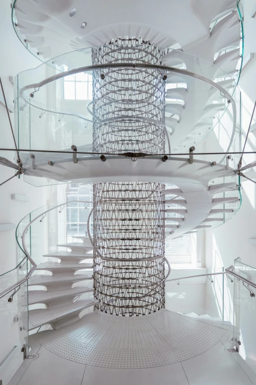 a large white spiral staircase in a very clean looking room