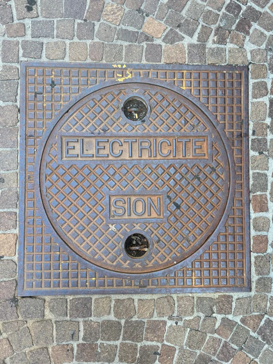 the manhole cover for electric is shown on the sidewalk