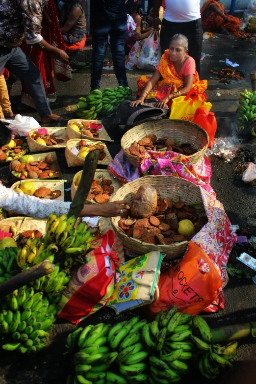woman selling fruit and vegetables from basket for sale