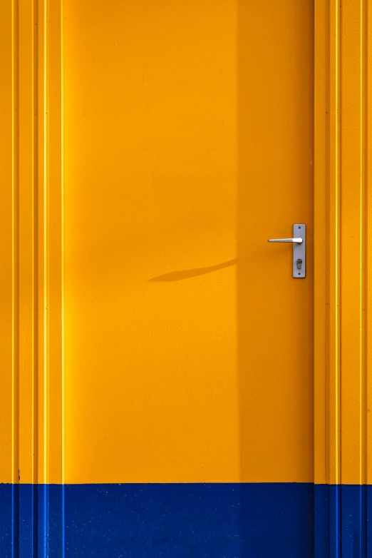 yellow and blue walls with a door handle on each side