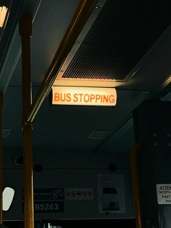 a bus stop sign is visible on the ceiling of the public area
